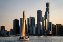 Boat Sailing In Front Of Chicago At Sunset