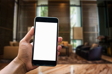 a woman hand holding smart phone device in the coffee shop or cafe background.