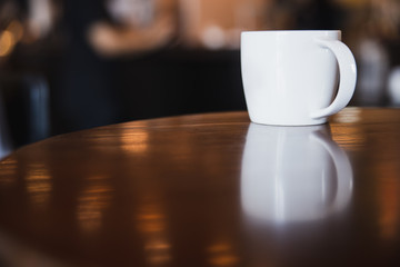 cup of coffee on wooden table in coffee shop with copy space