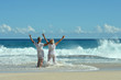 © aletia2011 - Portrait of happy elderly couple resting on beach waving hands