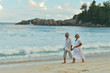 © aletia2011 - Portrait of elderly couple walking on tropical beach
