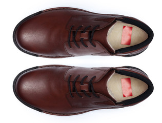 Classic male leather shoes isolated on a white, top view.