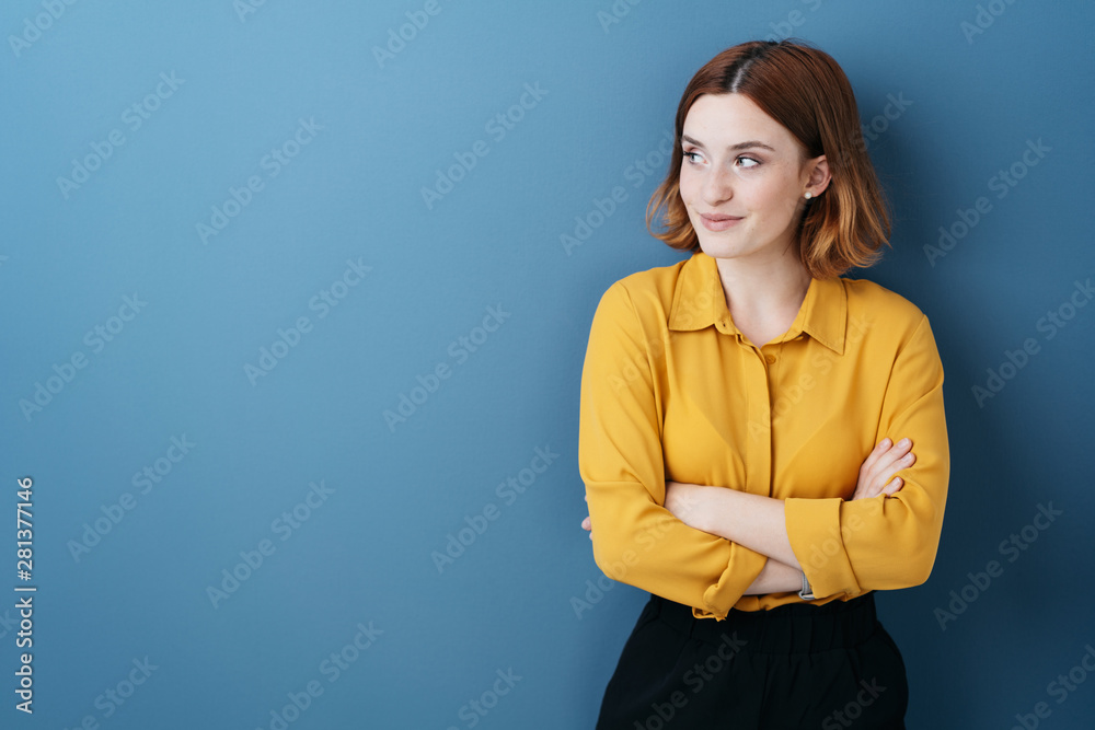 Young woman standing watching to the side - obrazy, fototapety, plakaty 