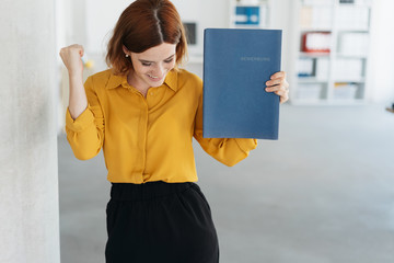 Exultant young woman celebrating getting a job