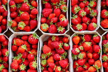 Many Fresh Strawberries In Boxes For Sale At A Fruit Market Outdoors. Top View. Healthy Food