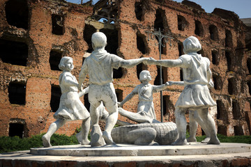 Volgograd/Russia-18.06.2016:The statue of with circle of kids and crocodile and destroyed building