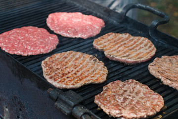 Street food. Fry meat patties (burgers) fresh beef on the grill