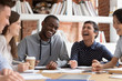 © fizkes - Smiling multiracial young people have fun studying together
