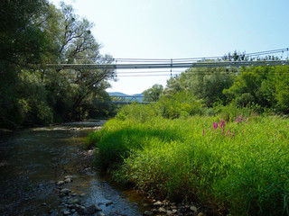 Gas pipe on the bridge leading over the river;