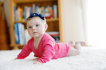 Wall Mural - Portrait of little tiny baby girl of 5 months indoors at home