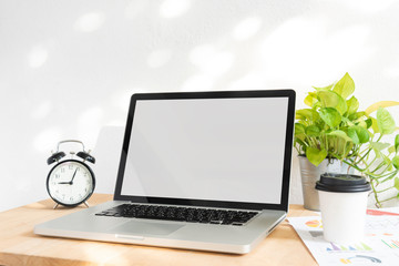 Wall Mural - computer laptop blank screen for mockup creative design technology template on wood table.