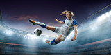 Fototapeta Sport - Female Soccer player in action on a professional soccer stadium. Girl playing soccer