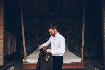 Wall Mural - stylish groom getting prepared for wedding