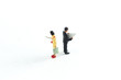 © Sean - Miniature People Looking at Media/Newspaper/Phone Standing on a White Isolated Background