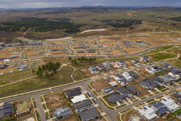 Aerial view of streets, houses and housing development in the newly established suburb of Denman Prospect in Canberra, Australia