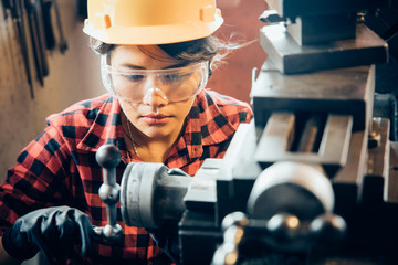 Asian beuatiful woman working with machine in the factory engineer and working woman concept or woman day