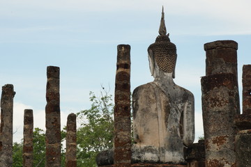 The back of stone Buddha statue inside a pagoda