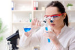 © Elnur - Young female chemist working in the lab