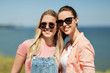 © Syda Productions - leisure and friendship concept - happy smiling teenage girls or best friends in sunglasses at seaside in summer