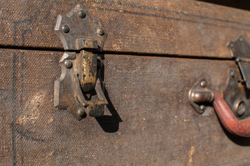 Old weathered retro vintage grunge suitcase handle and metal latch lock closeup