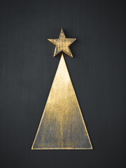 concept christmas tree rustic decoration, wooden golden handmade fir on dark background