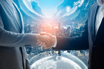 Close up of businessmen shaking hands. Global network and a world map in the foreground. block chain concept.