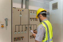 Asian Electric Engineer Holding Clipboard For Checking And Monitoring The Electrical System In The Control Room,Technician Thailand People Working