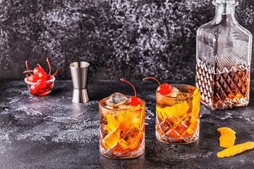 Wall Mural - Old fashioned cocktail with cherries and orange twist.