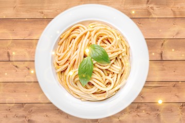 Spaghetti pasta with tomatoes and parsley on  table.