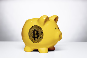 yellow piggy bank with bitcoin symbol