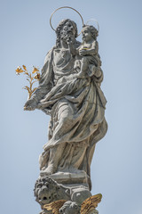 Statue of Saint Joseph with a child on top of the column of fountain at Charles Square, New Town Hall, Prague, Czech Republic, details, closeup