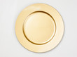 Gold plate on white backdrop