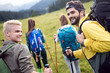© NDABCREATIVITY - Group of young friends hiking in countryside. Multiracial young people on country walk.
