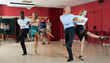 © JackF - Young positive people practicing vigorous jive movements in dance class