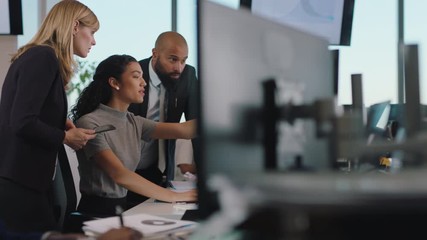 business woman team leader meeting with colleagues using computer pointing at screen office manager sharing ideas helping coworkers discussing strategy in corporate workplace