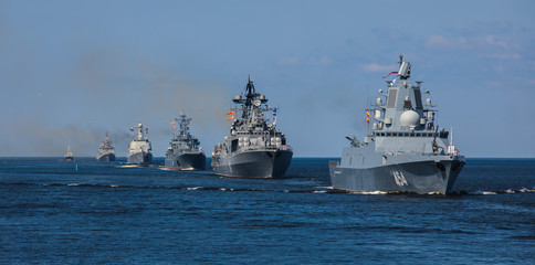 A line ahead of modern russian military naval battleships warships in the row, northern fleet and baltic sea fleet, summer sunny day