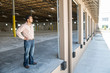 © Mint Images - Architect standing at entrance in warehouse