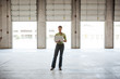 © Mint Images - Architect using laptop while standing in warehouse