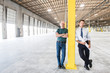 © Mint Images - Portrait of architects leaning on pillar in warehouse