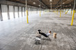 © Mint Images - Architect relaxing on chair in warehouse