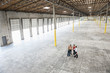 © Mint Images - Architects checking out interior of warehouse