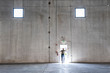 © Mint Images - Rear view of worker standing at door of warehouse