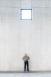 © Mint Images - Worker standing under window in warehouse