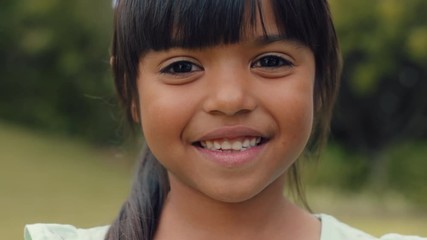 portrait beautiful little girl smiling looking happy cute child having fun in sunny park outdoors en