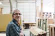© Mint Images - Portrait of carpenter standing in workshop