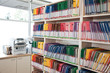 © Mint Images - View of colorful file folders arranged on shelf in dental office
