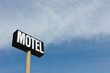 © Mint Images - Motel sign against cloudy sky