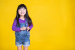 © paulaphoto - Portrait of young happy little asian girl in uniform isolated on yellow background with copy space. Education for toddler or preschool, childhood lifestyle back to school concept