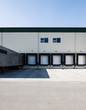 © Mint Images - Exterior view of warehouse loading dock with truck