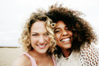 © Mint Images - Portrait of smiling friends enjoying beach